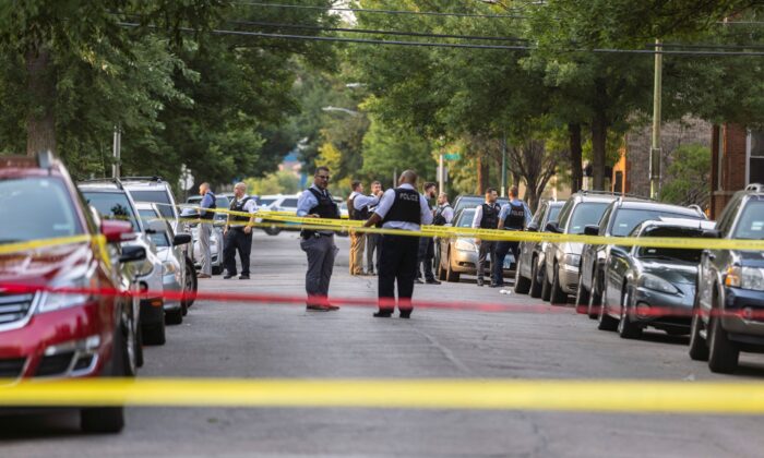 Police investigate the scene of a shooting near 1324 S Christiana Ave in Chicago's Lawndale neighborhood, Wednesday, July 21, 2021. (Anthony Vazquez/Chicago Sun-Times via AP)