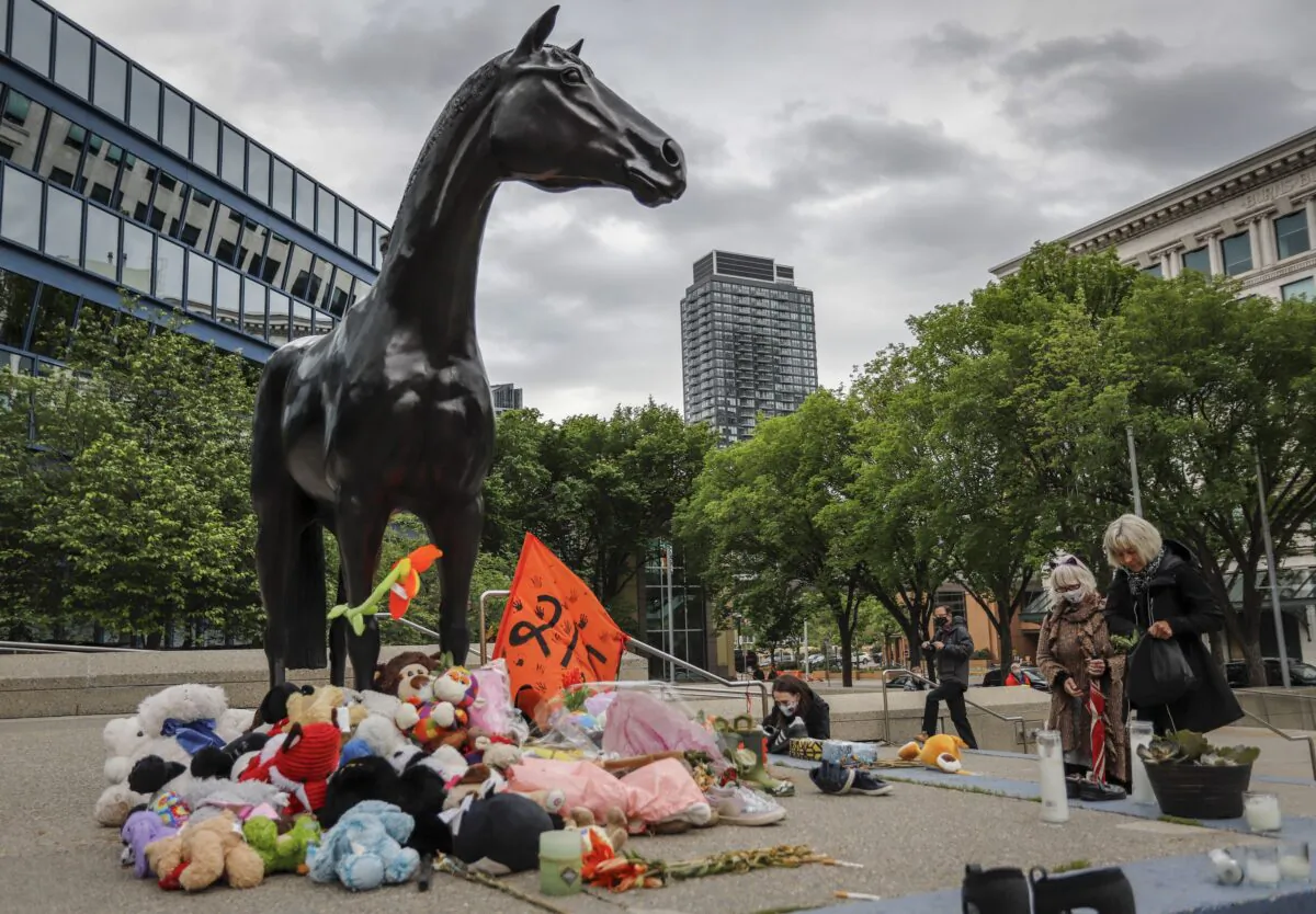 A memorial to the 215 potential unmarked graves discovered using ground-penetrating radar at the former Kamloops Indian Residential School in B.C., outside city hall in Calgary on June 8, 2021. (The Canadian Press/Jeff McIntosh)