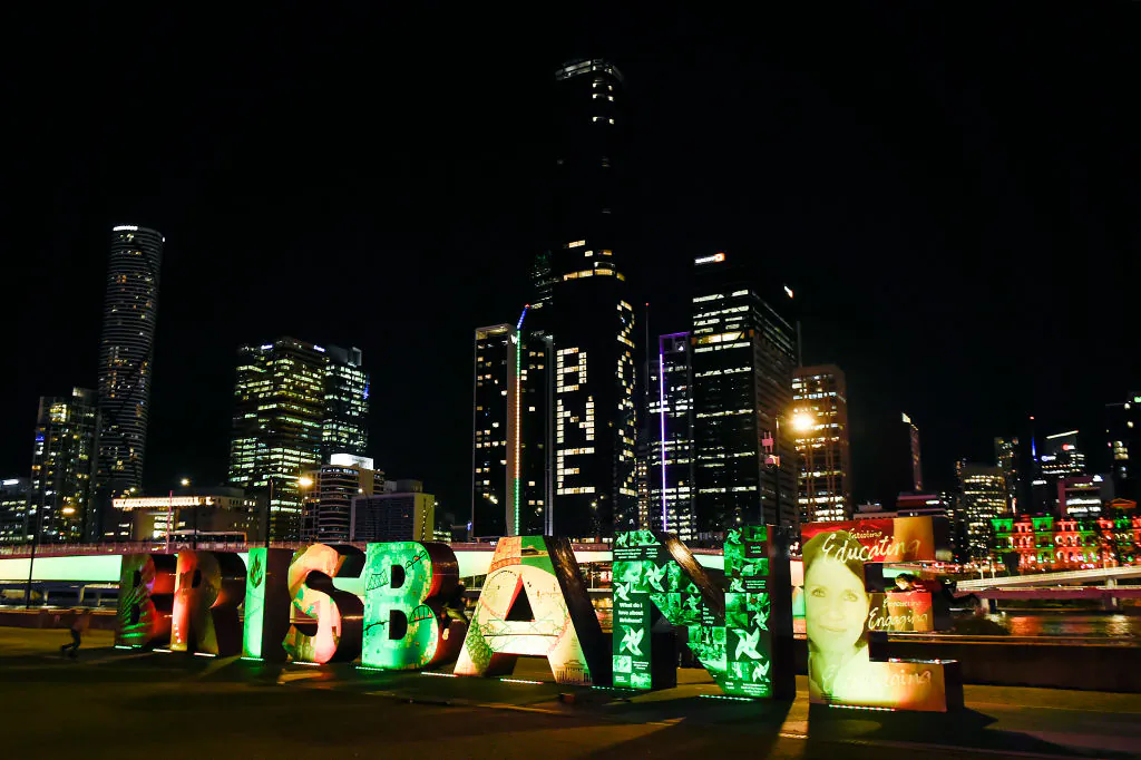 "BNE 2032" is displayed on a building during the announcement of the host city for the 2032 Olympic Games, watched via live feed in Tokyo, at the Brisbane Olympic Live Site in Brisbane, Australia, on July 21, 2021 (Albert Perez/Getty Images)