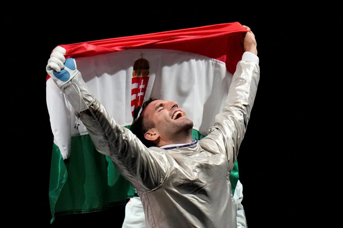 Aron Szilagyi of Hungary celebrates winning the gold medal after defeating Luigi Samele of Italy compete in the men's individual final Sabre competition at the 2020 Summer Olympics, in Chiba, Japan, on July 24, 2021. (AP Photo/Hassan Ammar)