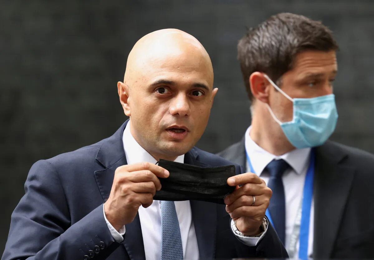 Britain's Health Secretary Sajid Javid holds a face mask as he leaves the Downing Street in London on June 30, 2021. (Henry Nicholls/Reuters)