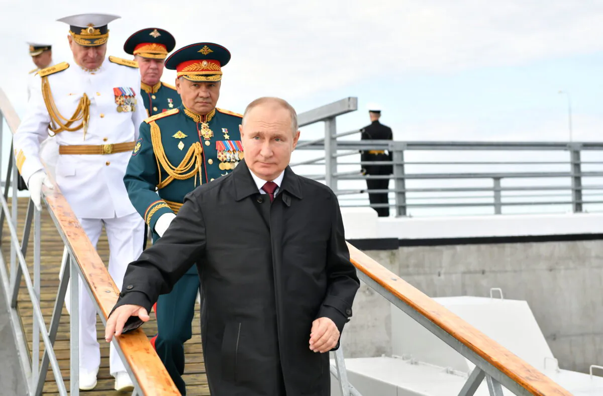 Russia's President Vladimir Putin and Defense Minister Sergei Shoigu attend the Navy Day parade in Saint Petersburg, Russia, on July 25, 2021. (Sputnik/Aleksey Nikolskyi/Kremlin via Reuters)