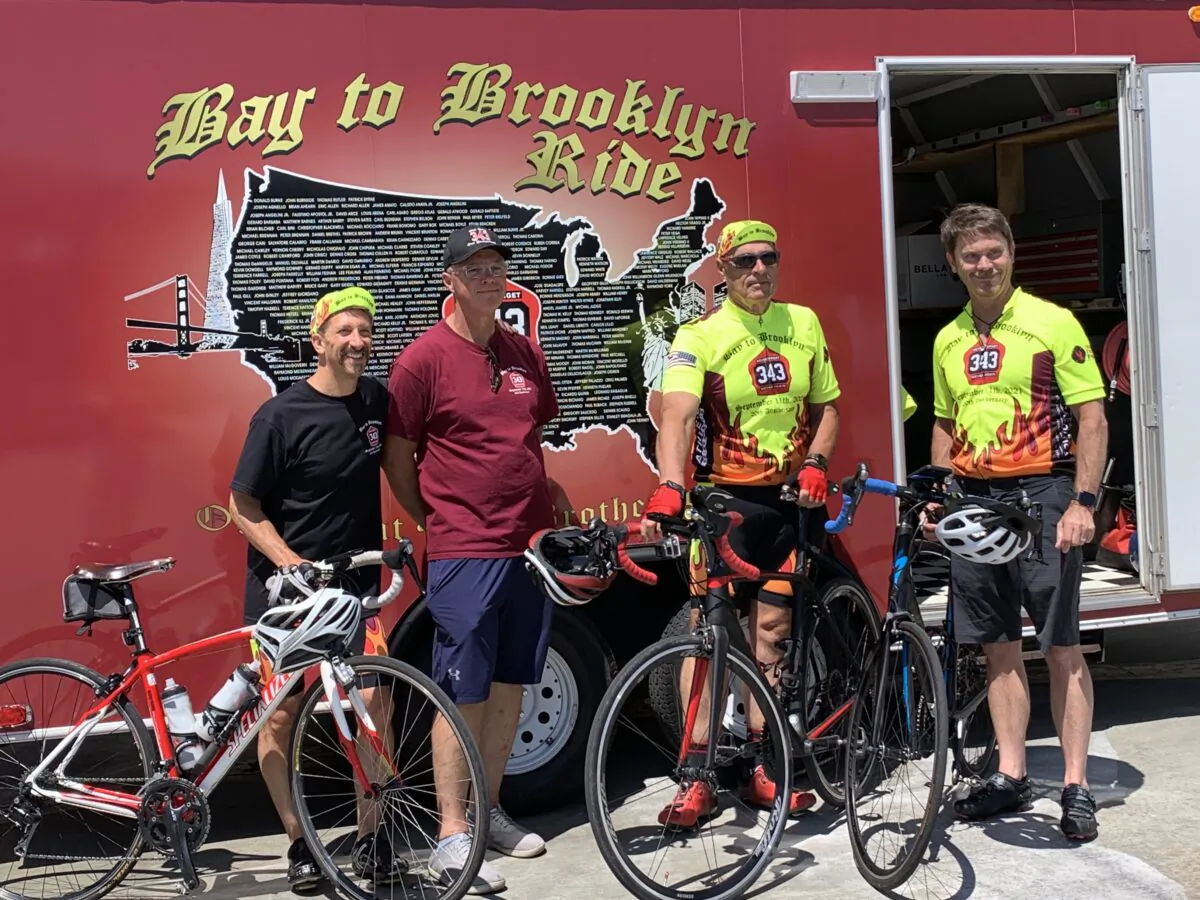 Four members of the 2021 Bay to Brooklyn team in front of the trailer on July 20, 2021. (Cynthia Cai/The Epoch Times)