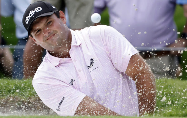 Patrick Reed plays a shot