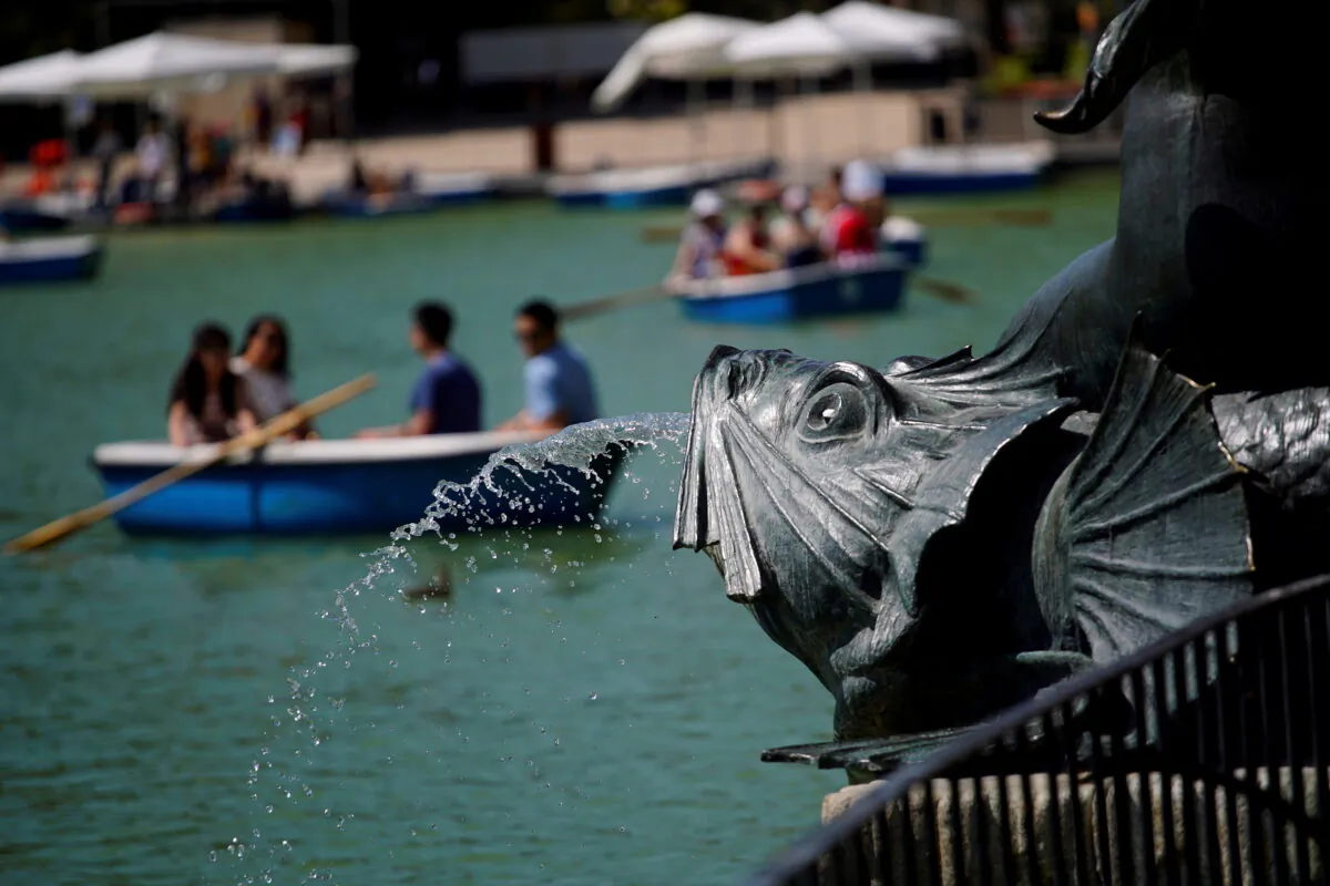 People enjoy boat rides in Retiro Park in Madrid, Spain, on June 26, 2019. (Juan Medina/Reuters)