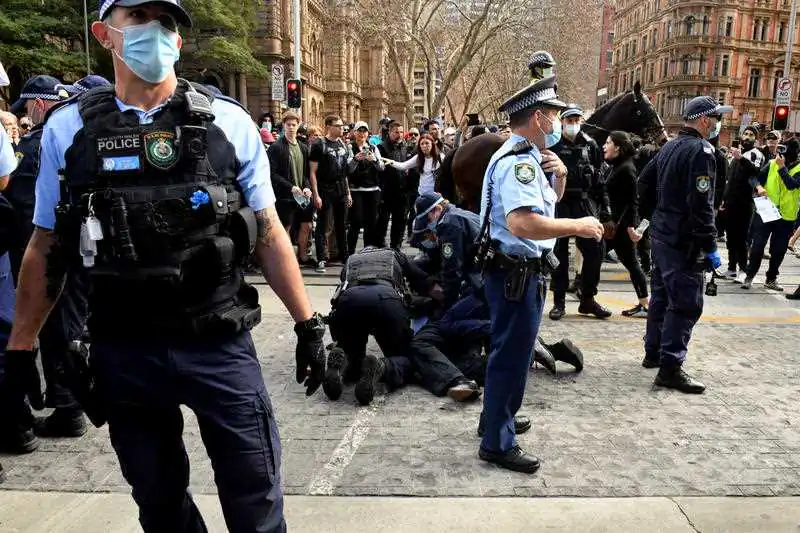 A protester is arrested by police at Sydney Town Hall during the ‘World Wide Rally For Freedom’ anti-lockdown rally at Hyde Park in Sydney, Saturday, July 24, 2021. (AAP Image/Mick Tsikas)