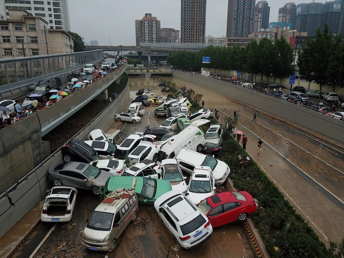 An aerial view shows cars sitting in floodwaters at the entrance of a tunnel after heavy rains hit the city of Zhengzhou, China, on July 22, 2021. (NOEL CELIS/AFP via Getty Images)