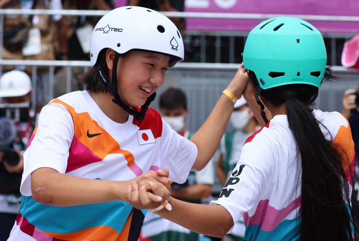 Gold medalist Momiji Nishiya of Japan and bronze medalist Funa Nakayama of Japan celebrate in Tokyo, Japan on July 26, 2021. (Reuters/Lucy Nicholson)