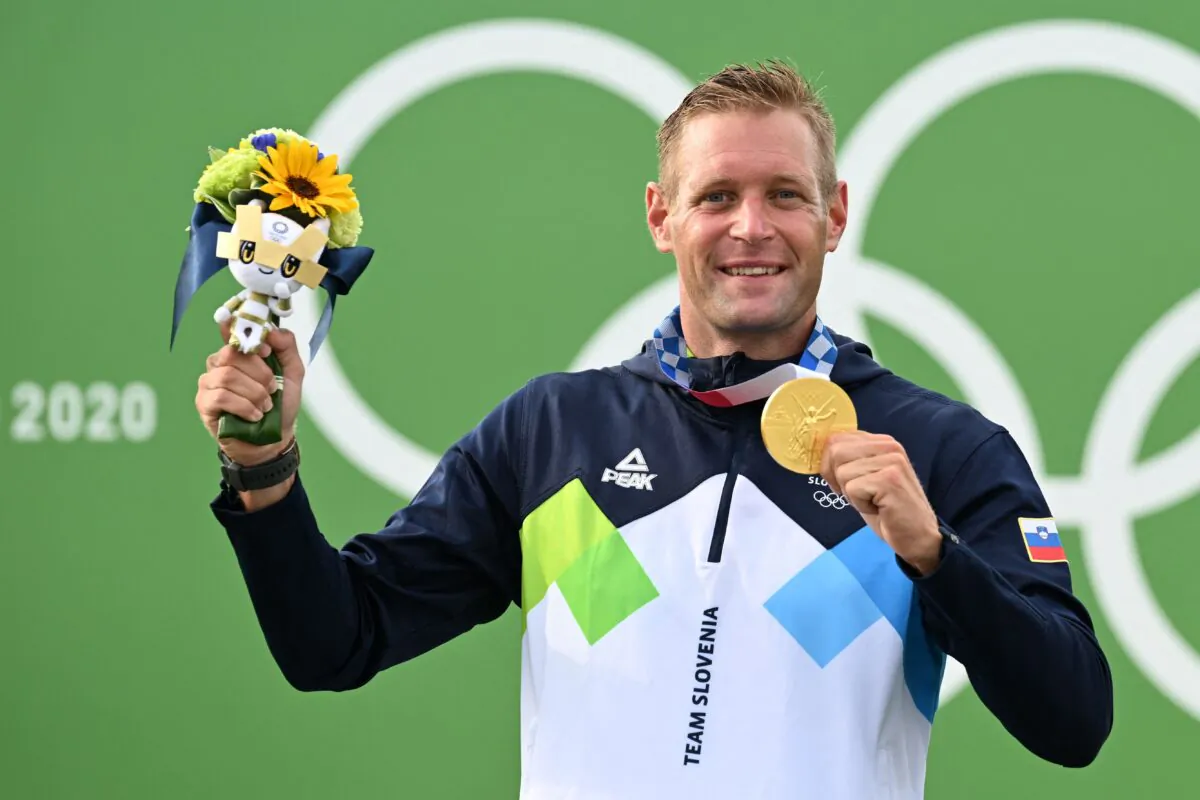 Slovenia's Benjamin Savsek poses with his gold medal on the podium following the men's Canoe Slalom final during the Tokyo 2020 Olympic Games at Kasai Canoe Slalom Centre in Tokyo, Japan, on July 26, 2021. (Charly Triballeau/AFP via Getty Images)