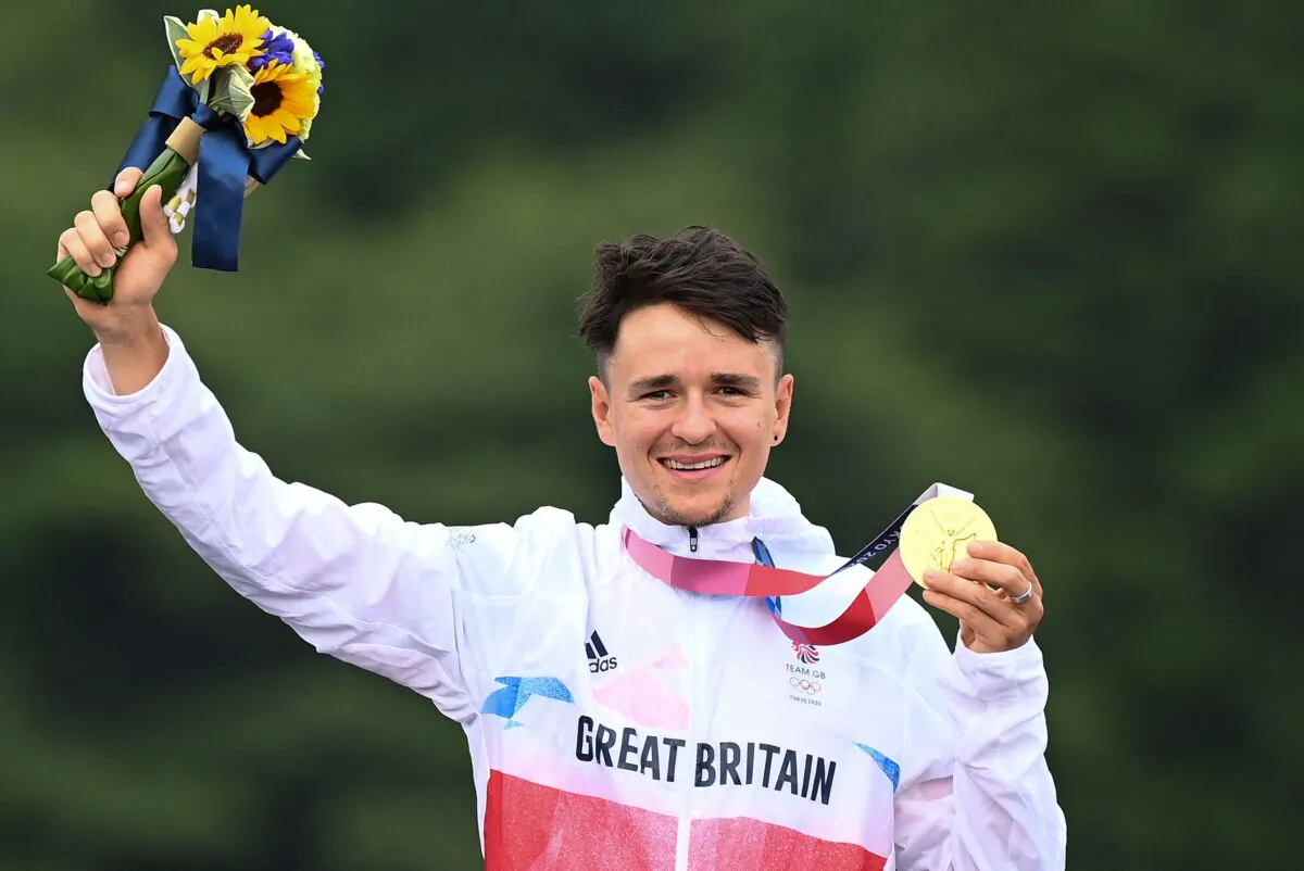 Britain's Thomas Pidcock celebrates after winning the gold medal at the medal ceremony of the cycling mountain bike men's cross-country event during the Tokyo 2020 Olympic Games at the Izu MTB Course in Izu, Japan, on July 26, 2021. (Greg Baker/AFP via Getty Images)