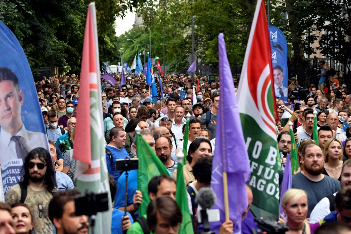 People march during a protest against the Hungarian government for allegedly using Pegasus spyware to monitor journalists, opposition leaders, and activists in Budapest, Hungary, on July 26, 2021. (Marton Monus/Reuters)