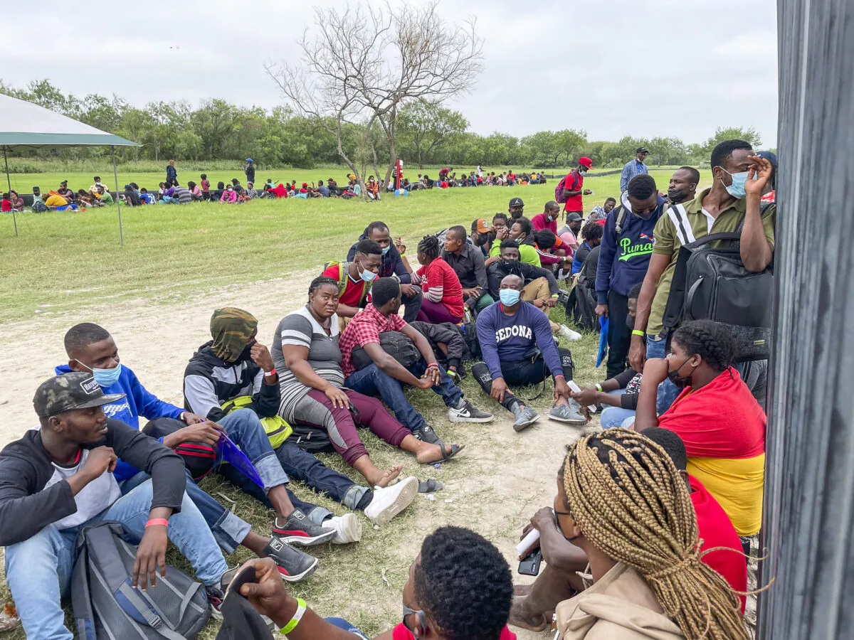 A group of illegal immigrants wait for Border Patrol after crossing the Rio Grande from Mexico into Del Rio, Texas, on July 25, 2021. (Charlotte Cuthbertson/The Epoch Times)