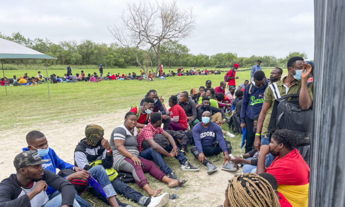 A group of more than 350 illegal immigrants wait for Border Patrol after crossing the Rio Grande from Mexico into Del Rio, Texas, on July 25, 2021. (Charlotte Cuthbertson/The Epoch Times)