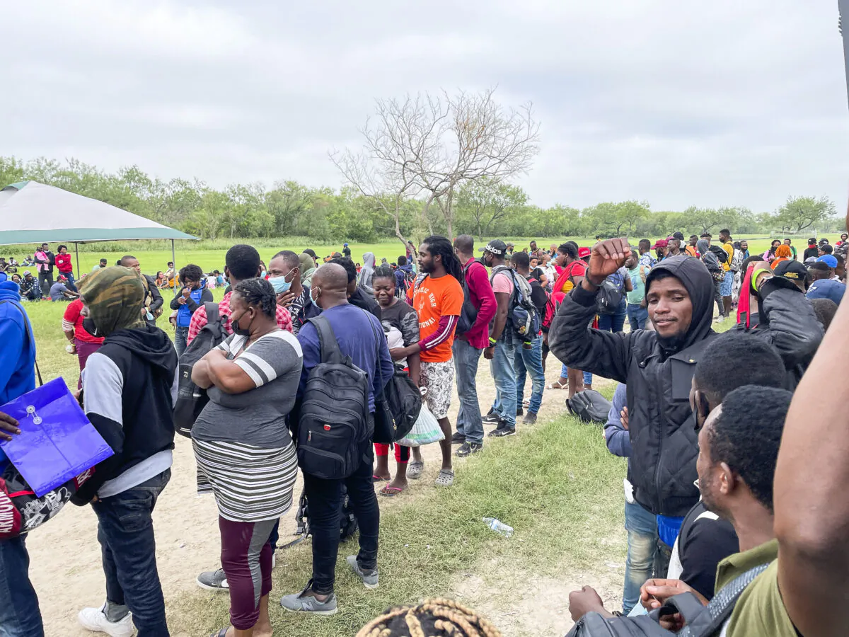A group of illegal immigrants waits for Border Patrol after crossing the Rio Grande from Mexico into Del Rio, Texas, on July 25, 2021. (Charlotte Cuthbertson/The Epoch Times)