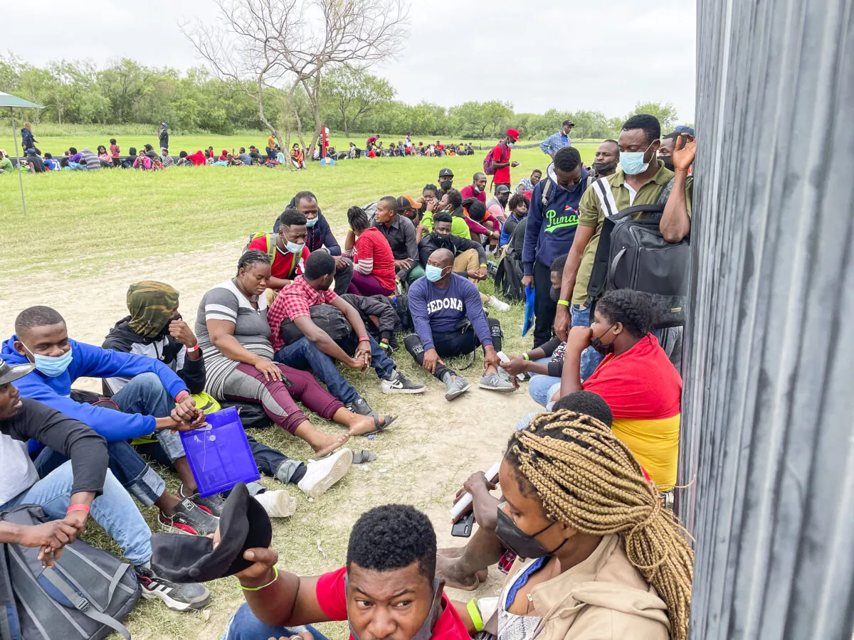 A group of more than 350 illegal immigrants wait for Border Patrol after crossing the Rio Grande from Mexico into Del Rio, Texas, on July 25, 2021. (Charlotte Cuthbertson/The Epoch Times)