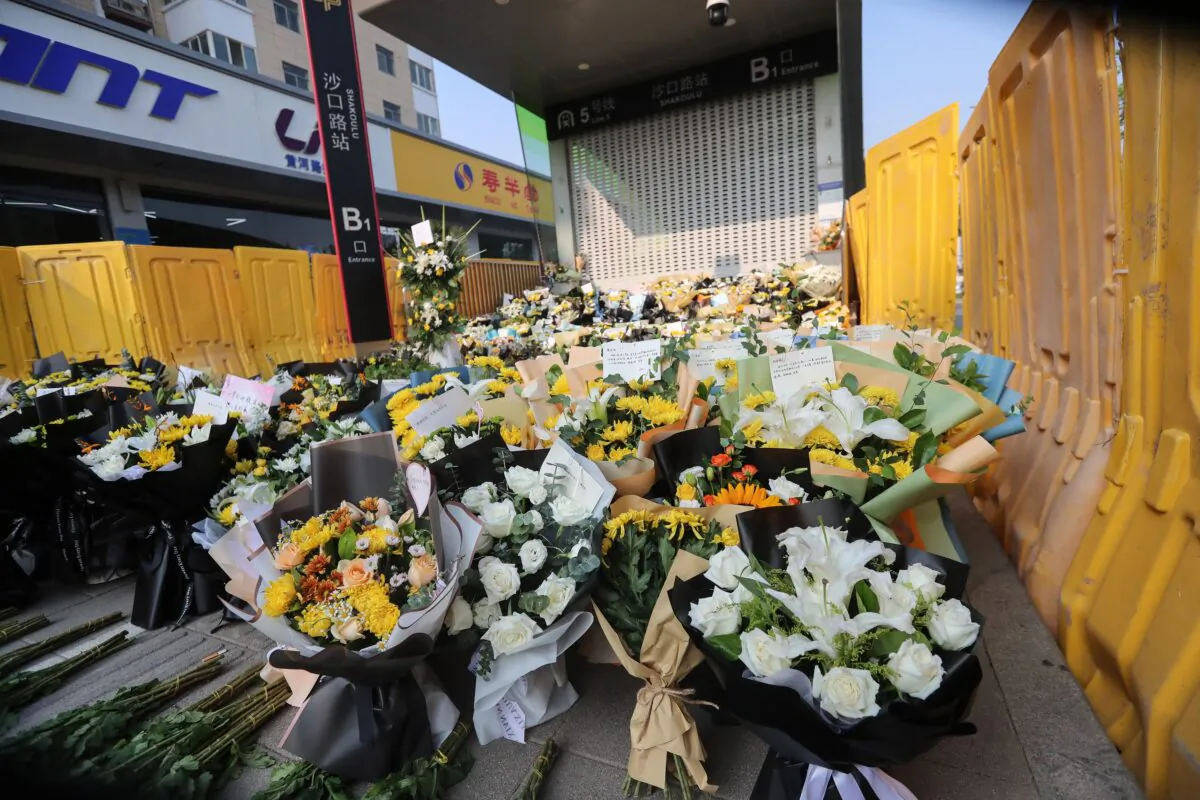 Flowers placed as tributes are seen in front of a metro station in memory of flood victims in Zhengzhou, Central China's Henan Province on July 27, 2021. (STR/AFP via Getty Images)
