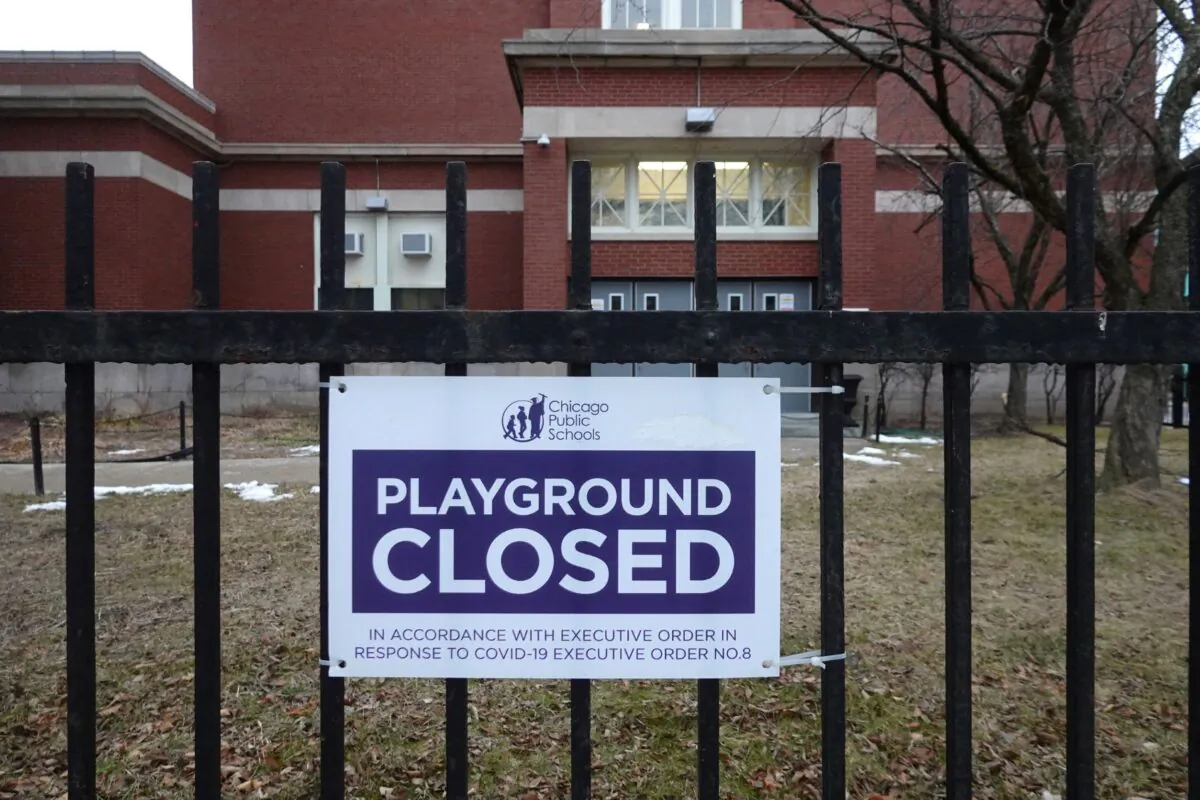 A sign outside of Columbus Elementary School lets visitors know that the playground has been closed, in Chicago, on Jan. 25, 2021. (Scott Olson/Getty Images)