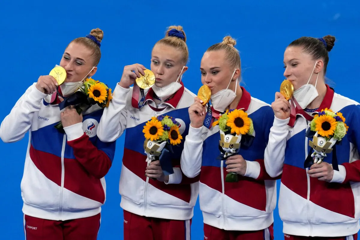 Russian Olympic Committee's artistic gymnastics women's team, from left, Liliia Akhaimova, Viktoriia Listunova, Angelina Melnikova and Vladislava Urazova celebrate after winning the gold medal at the 2020 Summer Olympics, in Tokyo on July 27, 2021. (Gregory Bull/AP Photo)