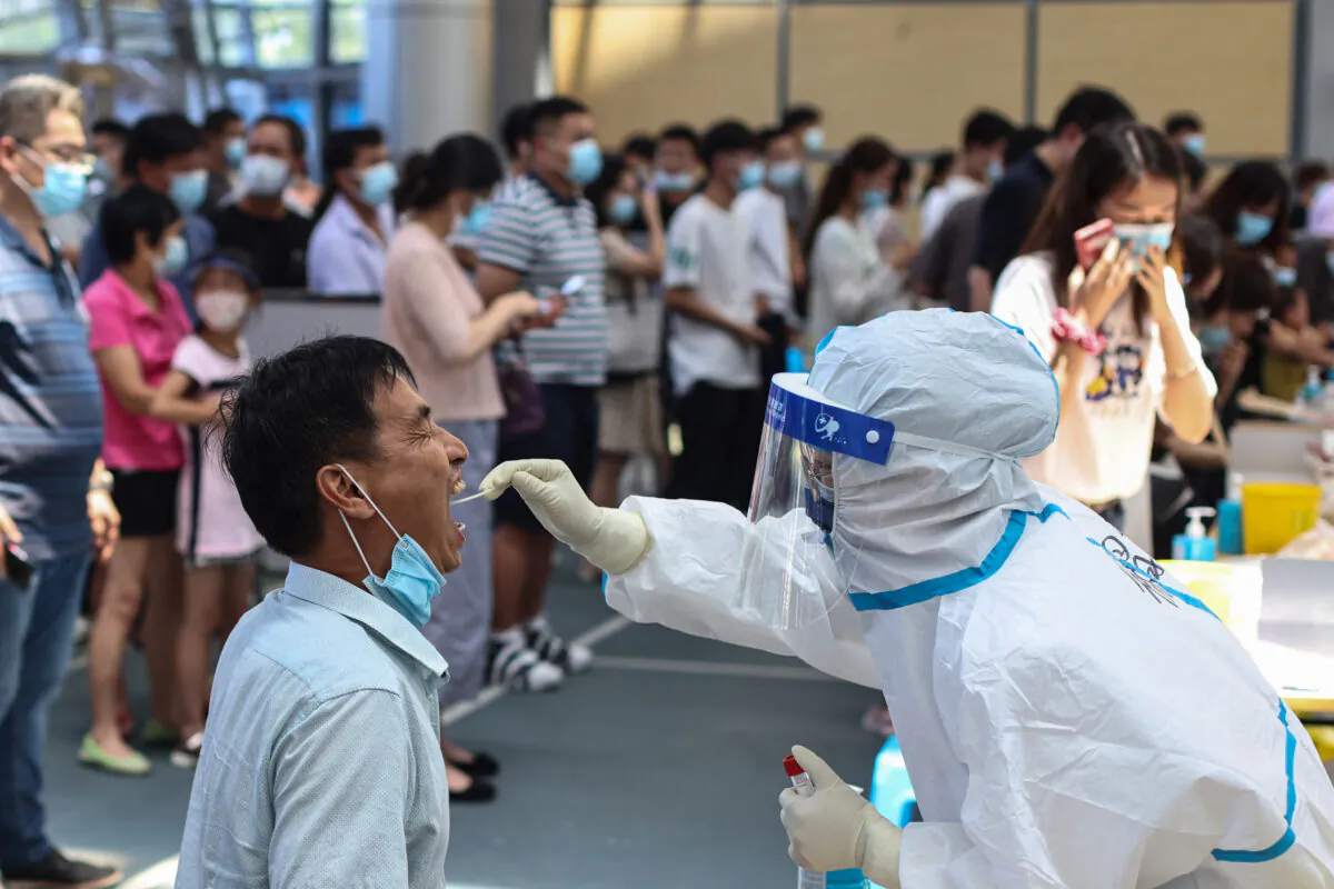 A resident receives nucleic acid test for the Covid-19 in Nanjing, in eastern Jiangsu province, China, on July 21, 2021. (STR/AFP via Getty Images)