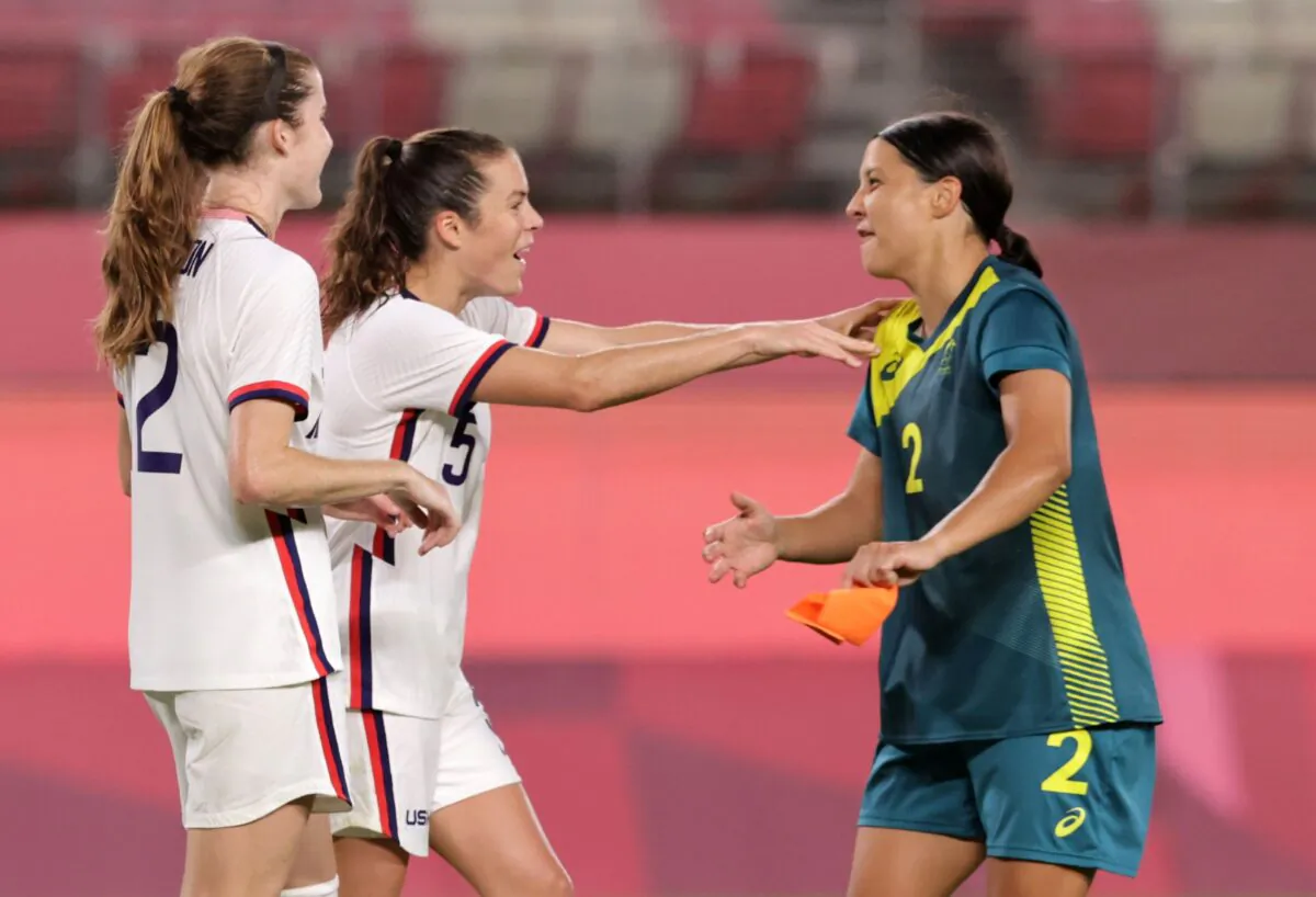 Samantha Kerr of Australia with Tierna Davidson and Kelley O'Hara of the United States after a women's soccer match at the 2020 Summer Olympics, in Kashima, Japan, on July 27, 2021. (Henry Romero/Reuters)