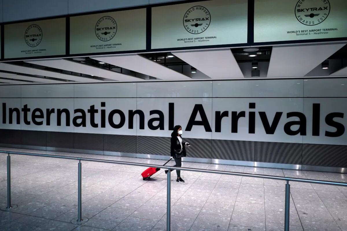A traveler walks at Terminal 5 in Heathrow Airport in London on July 26, 2020. (Henry Nicholls/Reuters)