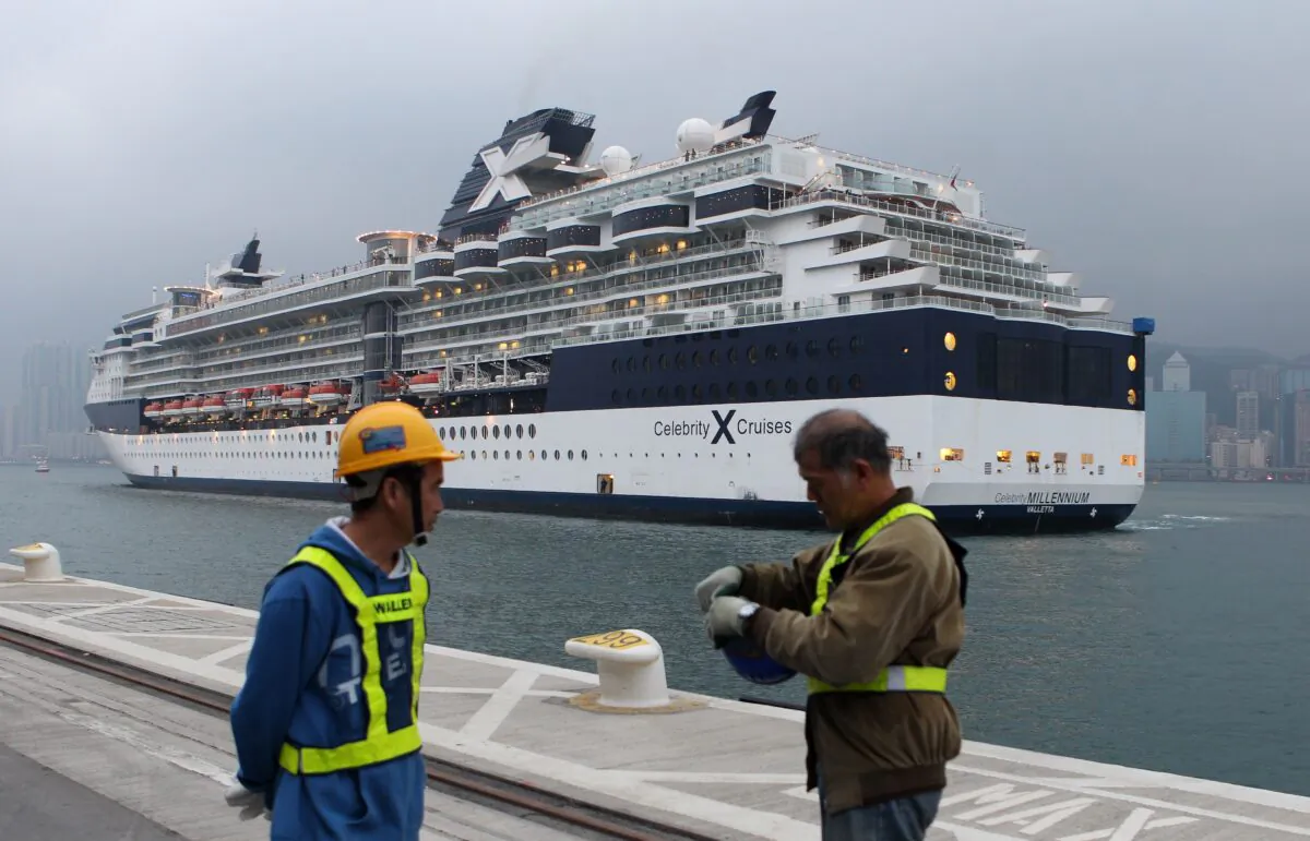 Workers prepare for the arrival of the "Celebrity Millennium" cruise ship on March 16, 2013. (Dale de la Rey/AFP via Getty Images)