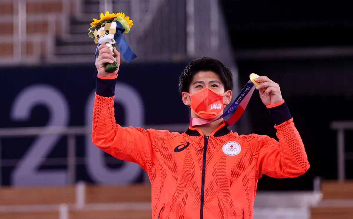 Daiki Hashimoto of Team Japan poses with his gold medal for the Men's Gymnastics All-Around Final at the Tokyo 2020 Olympic Games at Ariake Gymnastics Centre in Tokyo, Japan, on July 28, 2021. (Lindsey Wasson/Reuters)