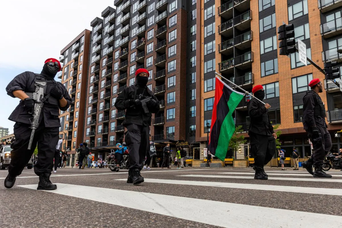 An armed group calling themselves "The Originals of the Minneapolis Black Panthers" marches with other protesters during an event in remembrance of George Floyd in Minneapolis, Minn., on May 23, 2021. (Kerem Yucel/AFP via Getty Images)