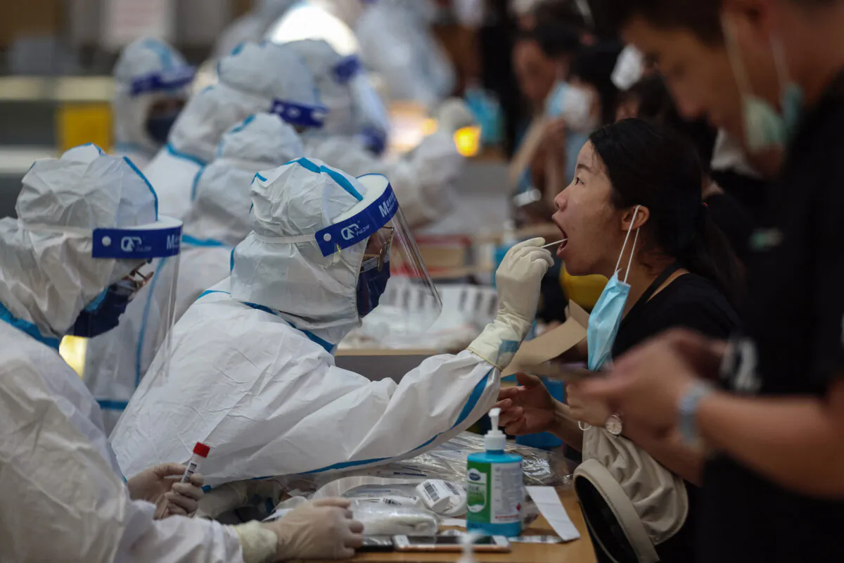 A resident receives nucleic acid test for the Covid-19 coronavirus in Nanjing, in eastern Jiangsu Province, on July 21, 2021. (STR/AFP via Getty Images)