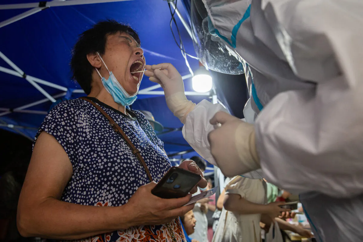 A resident is receiving a COVID-19 test in Nanjing, in eastern China’s Jiangsu Province on July 21, 2021. (STR/AFP via Getty Images)