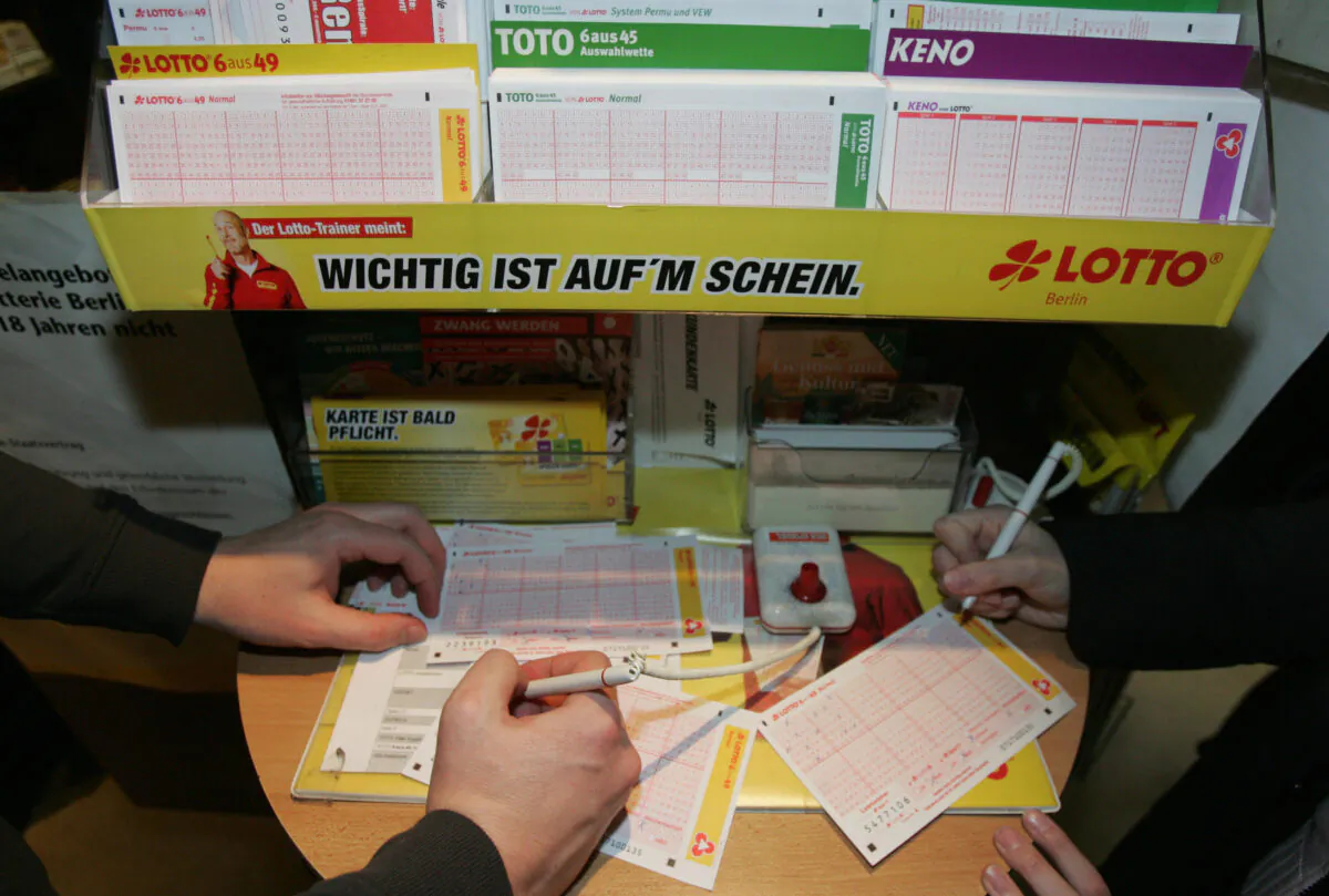 People fill out Lotto tickets in Germany in a file photo. (John Macdougall/AFP via Getty Images)