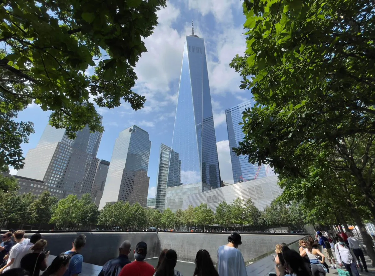 One World Trade Center building is seen as people visit the 9/11 memorial in New York on July 18, 2021. (Daniel Slim/AFP via Getty Images)
