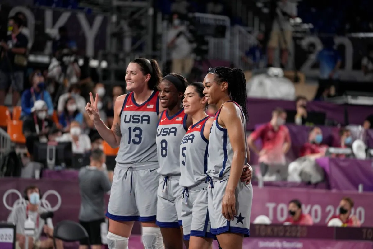 United States' Stefanie Dolson (13), Jacquelyn Young (8), Kelsey Plum (5), and Allisha Gray celebrate after defeating the Russian Olympic Committee in a women's 3-on-3 gold medal basketball game at the 2020 Summer Olympics, in Tokyo, Japan, on July 28, 2021. (Jeff Roberson/AP Photo)