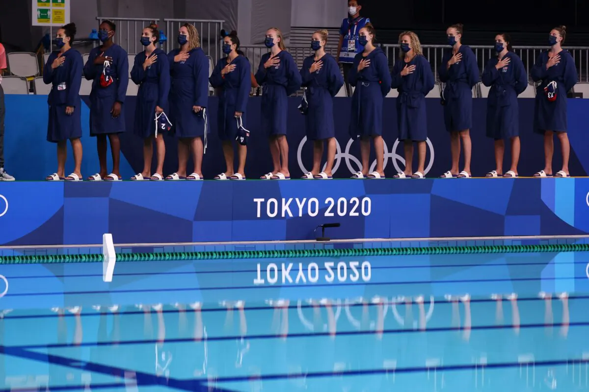 U.S. women's water polo team members listen to their national anthem ahead of a match at the 2020 Summer Olympics in Tokyo, Japan, on July 28, 2021. (Kacper Pempel/Reuters)