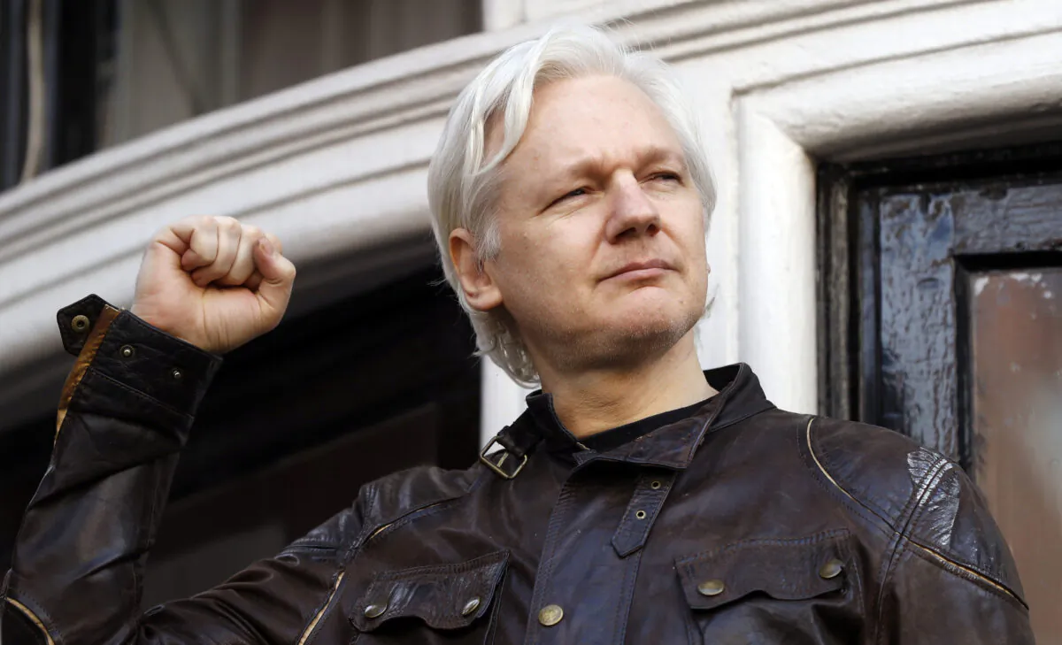 Julian Assange greets supporters outside the Ecuadorian embassy in London on May 19, 2017. (Frank Augstein/AP Photo)