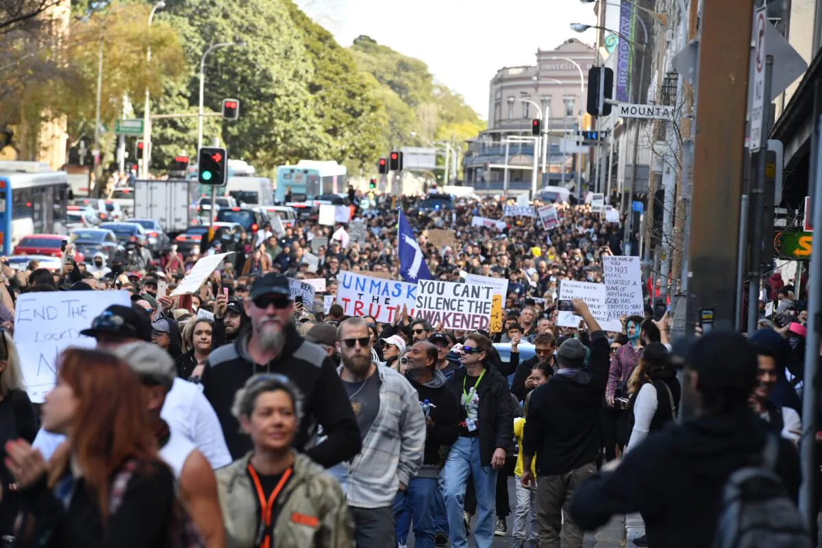 Protesters march along Broadway and George St toward Sydney Town Hall during the "World Wide Rally For Freedom" anti-lockdown rally at Hyde Park in Sydney, Australia, on July 24, 2021. (Mick Tsikas/AAP Image)
