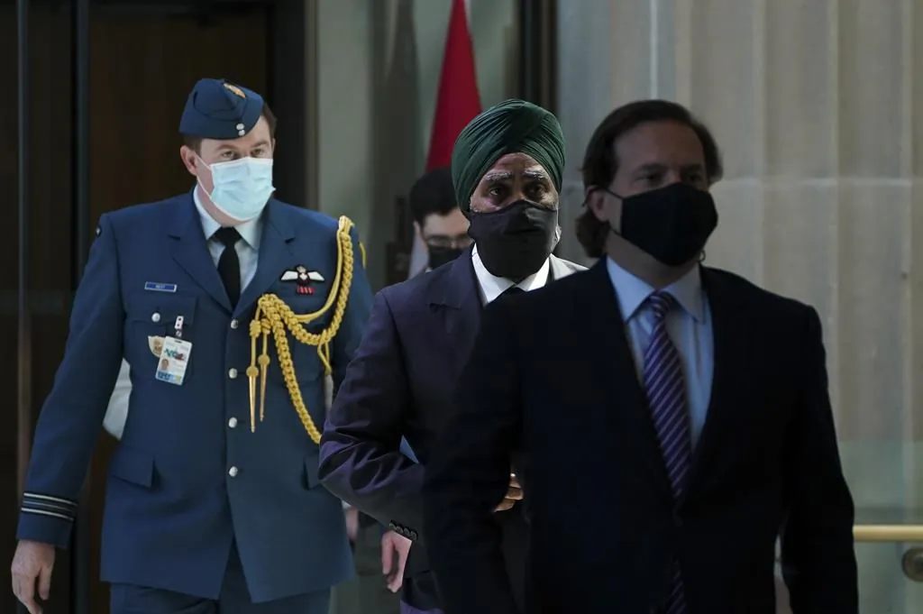 Immigration Minister Marco Mendicino, right, is joined by Harjit Sajjan, Minister of National Defence, second from right, as they arrive for a press conference in Ottawa on July 23, 2021. (The Canadian Press)