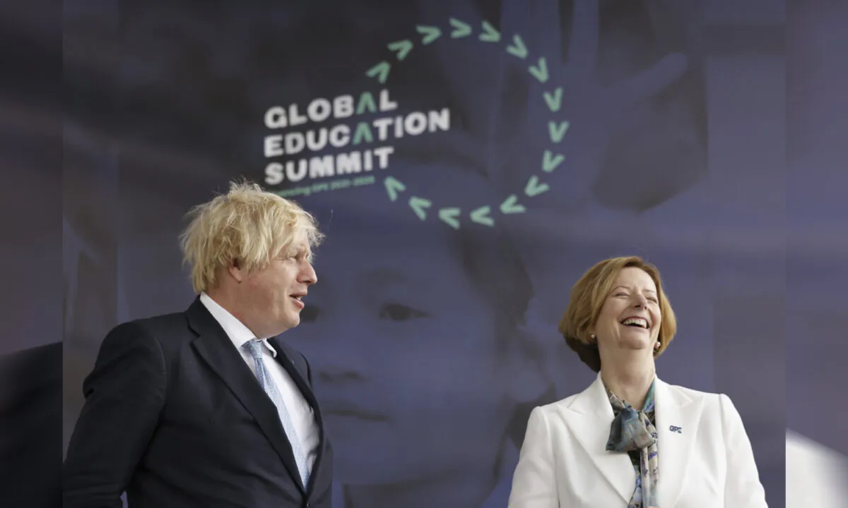 Britain's Prime Minister Boris Johnson alongside former PM of Australia Julia Gillard during a summit to raise funds for the Global Partnership for Education (GPE), in London, on July 29, 2021. (Tolga Akmen/PA via AP)