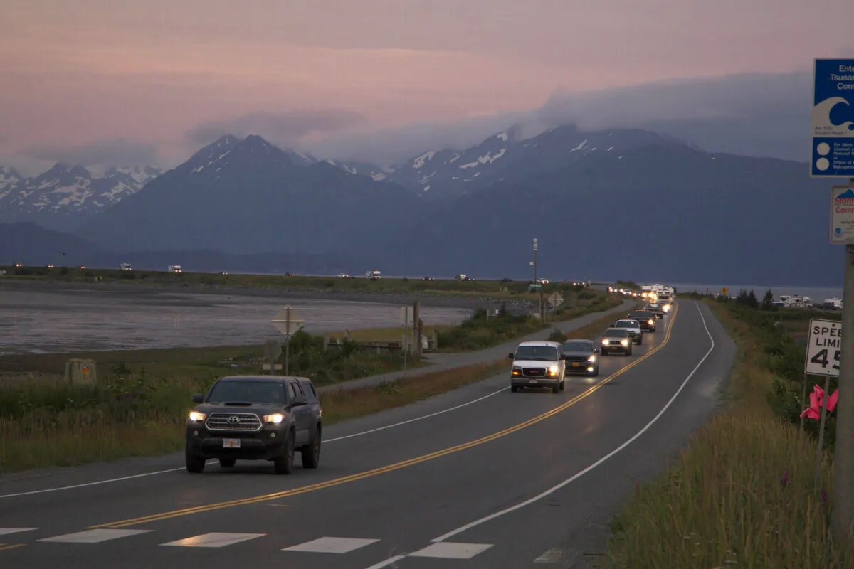 A line of cars evacuating the Homer Spit in Homer, Alaska, on July 28, 2021, after a tsunami warning was issued following a magnitude 8.2 earthquake. (Sarah Knapp/Homer News via AP)