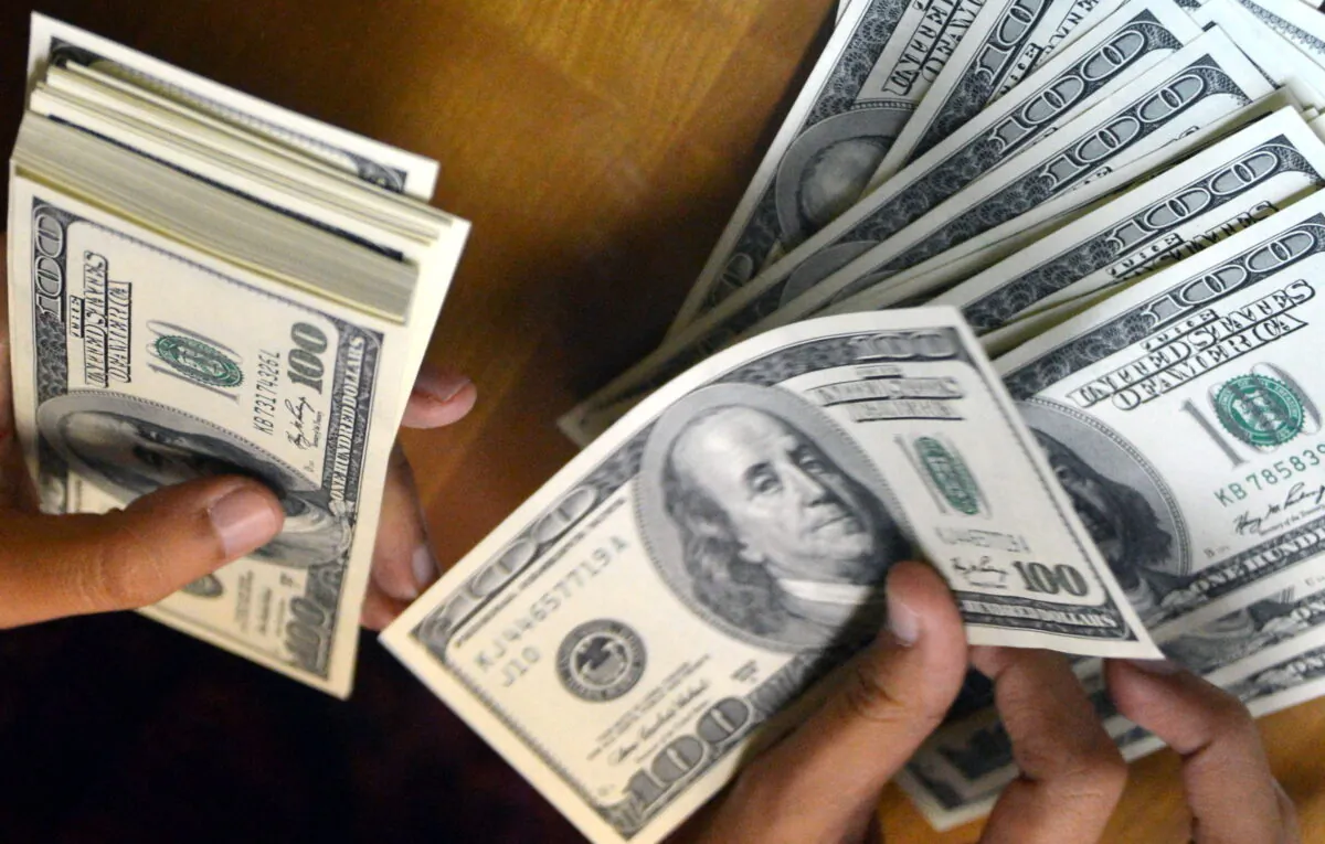 An employee counts USD notes at a money change outlet in Jakarta on June 14, 2013. (Bay Ismoyo/AFP via Getty Images)