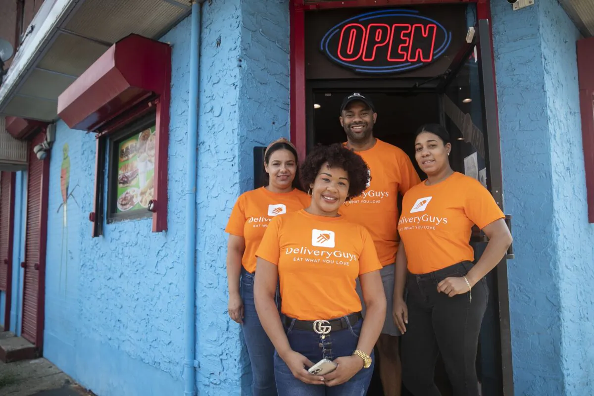 From left, clockwise, Lorainy Espinal, Victor Tejada, Nathalie Zapata, and Katty Dorporan pose for a portrait outside Sabor Rico Bakery in North Philadelphia. (Heather Khalifa/The Philadelphia Inquirer/TNS)
