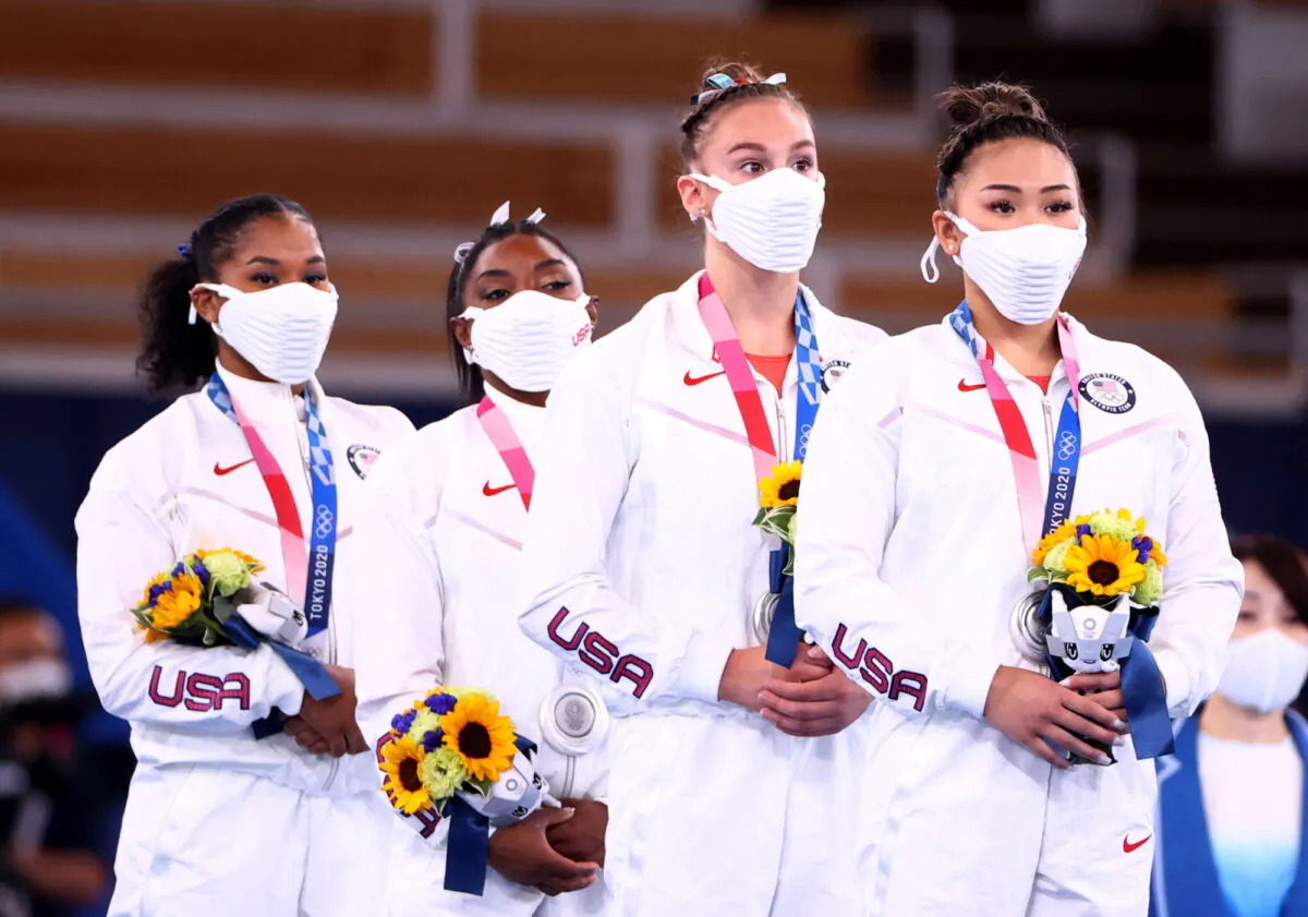 Jordan Chiles, Simone Biles, Grace McCallum, and Sunisa Lee of Team United States react on the podium after winning the silver medal during the Women's Gymnastics Team Final on day four of the Tokyo 2020 Olympic Games at Ariake Gymnastics Centre in Tokyo, Japan, on July 27, 2021. (Lindsey Wasson/Reuters)