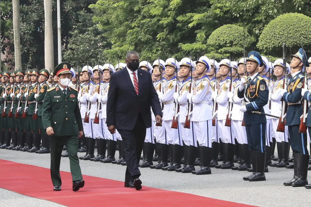 U.S. Secretary of Defense Lloyd Austin (R) with Vietnamese Defense Minister Phan Van Giang (L) inspects an honor guard in Hanoi, Vietnam, on July 29, 2021. (Nguyen Trong Duc/VNA via AP)