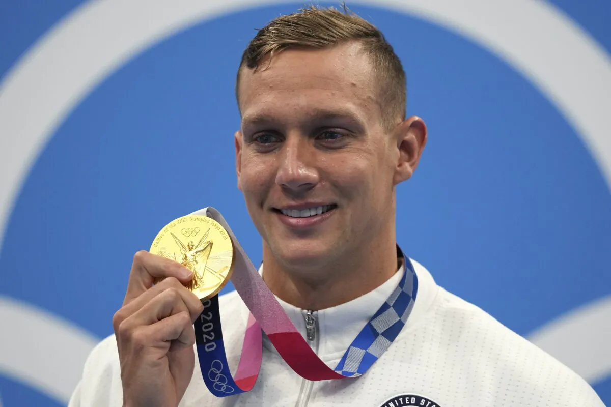 Caeleb Dressel of the United States poses with his gold medal for the men's 100-meter freestyle at the 2020 Summer Olympics in Tokyo, Japan on July 29, 2021. (Matthias Schrader/AP Photo)