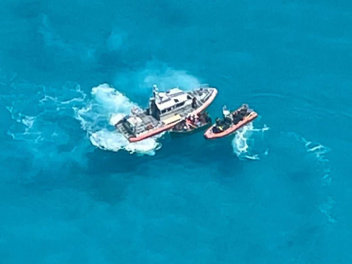 A Coast Guard Station Key West boat crew on scene with a 21-foot vessel with 22 people aboard approximately seven miles south of Key West, Fla., on July 23, 2021. (U.S. Coast Guard Auxiliary)