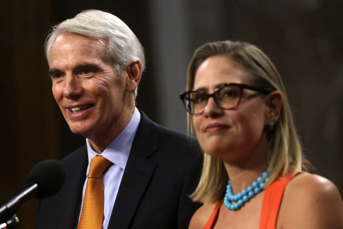 Sen. Rob Portman (R-Ohio) and Sen. Kyrsten Sinema (D-Ariz.) speak to reporters in Washington on July 28, 2021. (Alex Wong/Getty Images)