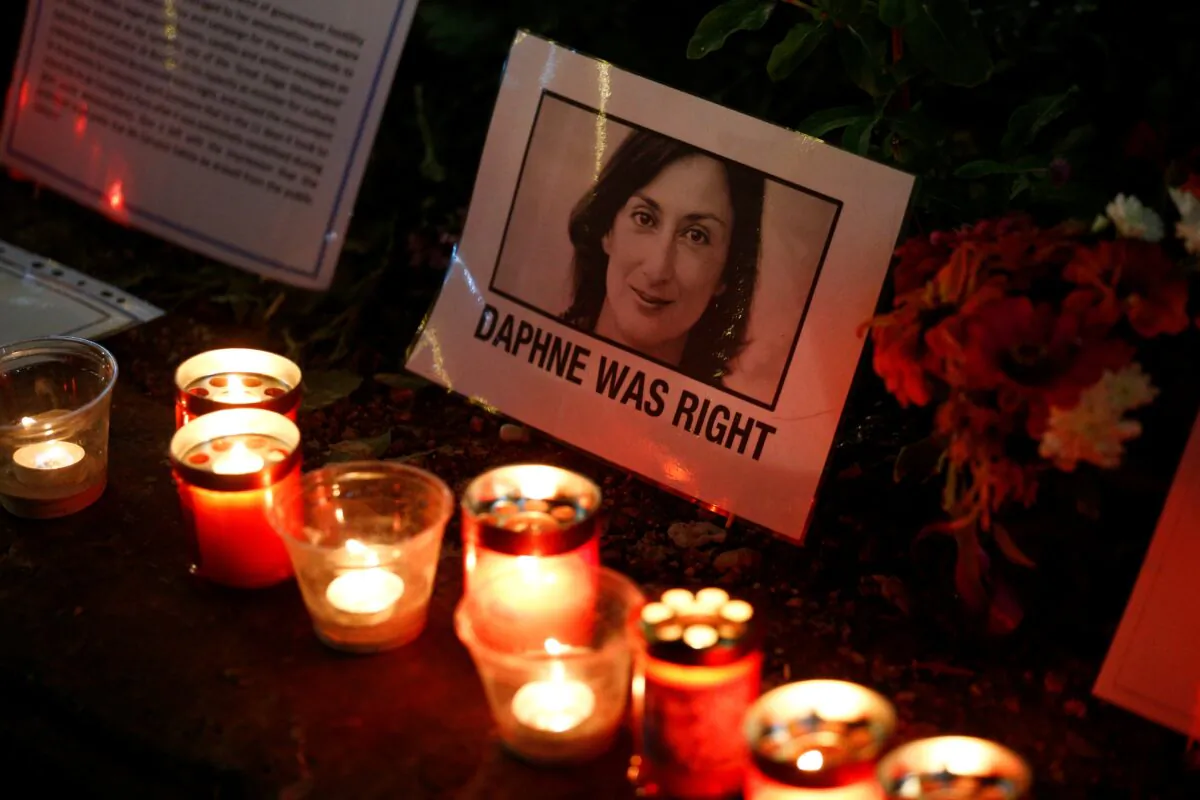 A sign reading "Daphne was right" is photographed at the Great Siege Square as people gather calling for the resignation of Joseph Muscat, following the arrest of one of the country's most prominent businessmen, as part of the investigation into the murder of journalist Daphne Caruana Galizia, in Valletta, Malta, on Nov. 20, 2019. (Guglielmo Mangiapane/Reuters)