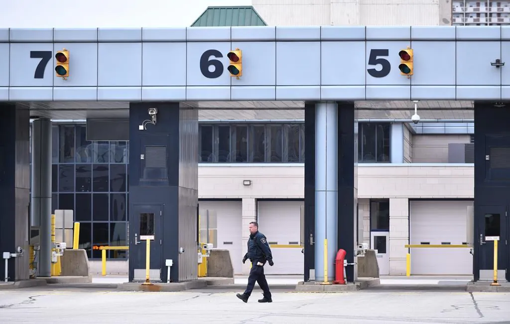 A Canada Border Services Agency worker is seen at the Canada-U.S. border crossing in Windsor, Ont., on March 21, 2020. (The Canadian Press/Rob Gurdebeke)