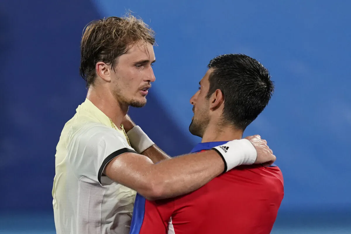 Alexander Zverev (L) of Germany, speaks with Novak Djokovic, of Serbia, after defeating Djokovic in the semifinal round of the men's tennis competition at the 2020 Summer Olympics in Tokyo, Japan, on July 30, 2021. (Patrick Semansky/AP Photo)