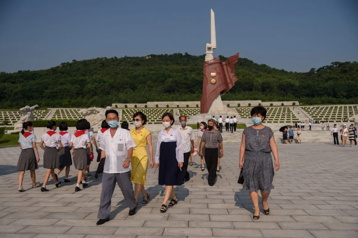 People walk at the Fatherland Liberation War Martyrs Cemetery as part of events marking the occasion of the 68th anniversary of the end of the Korean War in Pyongyang on July 27, 2021. (Kim Won Jin/AFP via Getty Images)
